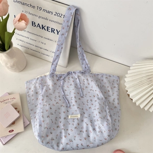 Detail of floral chiffon tote bag with drawstring closure and large capacity storage