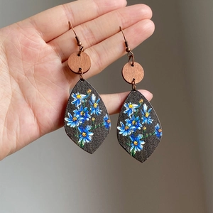 Vintage wooden teardrop earrings with blue hand-painted floral pattern and bronze ear hooks