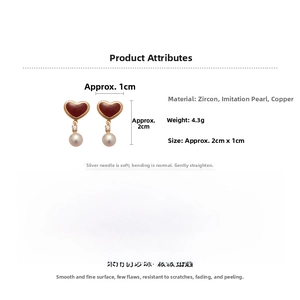 Detail view of pearl earrings with red enamel hearts and zircon stones, 2cm x 1cm size