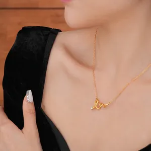 Elegant gold plated snake pendant necklace with a teardrop zircon worn by a model