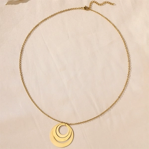 Macro detail of three interlocking 18k gold circles on a stainless steel necklace chain