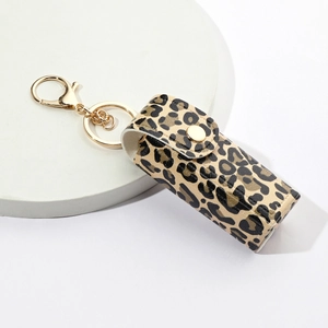 Leopard print PU leather lipstick holder keychain with gold metal hook on marble surface