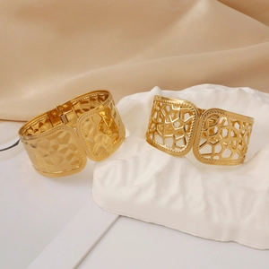 Polished 18k gold plated stainless steel bangles with hammered and cutout geometric design