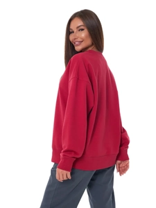 Detail view of red oversized sweatshirt featuring rib-knit cuffs and premium fabric texture