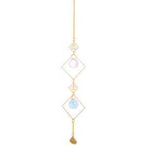 Detail of brass suncatcher featuring geometric frames and faceted crystal prisms