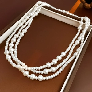 Detail of multi-layer white pearl necklace with gradient sizes in a jewelry box