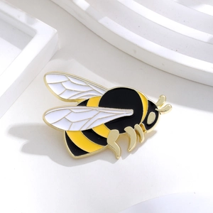 Detailed view of enamel bee brooch with gold plating and intricate wing textures