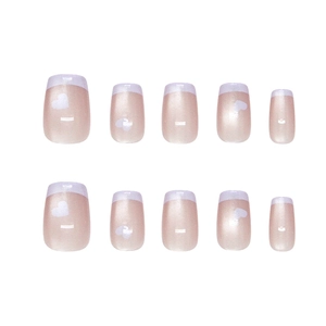 Handmade milky lavender French press-on nails with white heart designs and cat eye finish