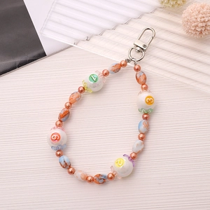 Detail view of colorful number beads with orange marble accents and silver lobster clasp