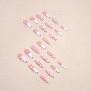 Long ballet coffin fake nails with white French gradient, floral art, and rhinestones