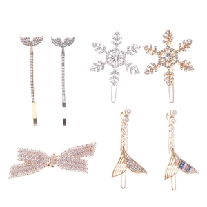 Elegant gold and silver hair clip set with pearl bows, rhinestones and snowflakes