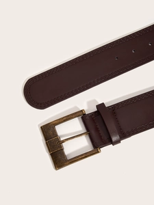 Detail of vintage dark brown leather belt with brass buckle and fine stitching