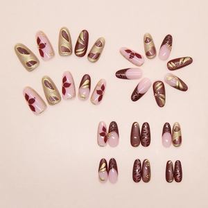 Detailed view of leopard print and floral press-on nails with golden metallic accents