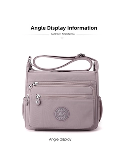 Detailed front view of mauve waterproof nylon crossbody bag with functional zip pockets