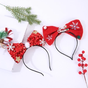 Detail of Christmas bow headbands with red sequins and Merry Christmas decorative text