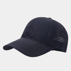 Detail of navy quick-dry baseball cap featuring laser-cut ventilation holes and side texture