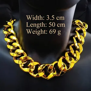 Detail view of 3.5cm wide gold-colored chunky chain necklace on black mannequin