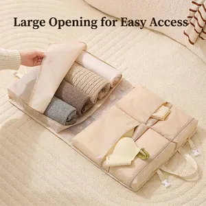 Beige travel clothes organizer bag with mesh window and compartments on a rug