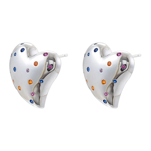 Macro view of French vintage heart earrings with colorful rhinestones on silver metal