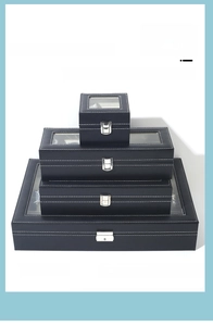 Stack of black PU leather watch display boxes with transparent glass windows and metal clasps