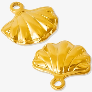 Detailed view of two polished gold seashell charms with rings for DIY jewelry making