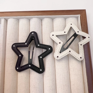 Star shaped PU leather hair clips with polka dots and stitching in black and white