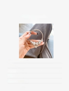 Detailed view of DIY charm bracelet with silver pendants and 14-20cm sizing specifications