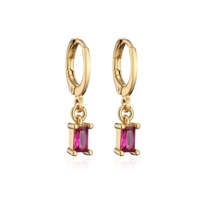 Macro detail of gold hoop earrings featuring rectangular red zircon pendant charms
