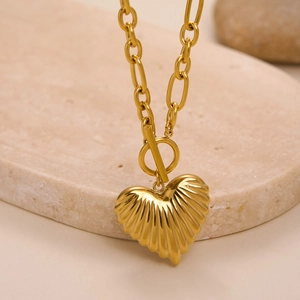 Detail of 18k gold plated necklace with textured heart pendant and OT clasp