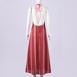 Detail view of the backless halter design with colorful wave patterns on a maxi dress