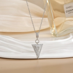 Elegant geometric V-shape pendant necklace with micro-paved zircons on silk background