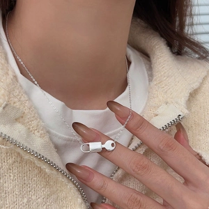 Close-up of 925 sterling silver lock and key pendant necklace on a model
