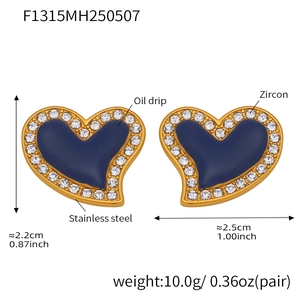 Macro detail of blue heart earring with gold stainless steel base and zircon stones