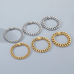 Detailed row of gold and silver stainless steel Cuban link bracelets on a gray background