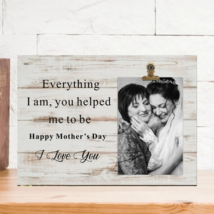 Detail of wooden photo holder with metal clip and Mother's Day message on a table