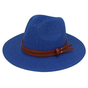 Detailed close-up of woven royal blue straw hat featuring a brown faux leather belt strap