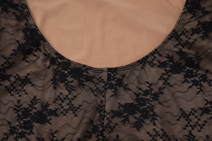 Detail of V-neck lace stitching with floral mesh pattern and nude lining for dress