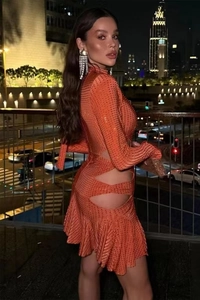 Détails de la mini robe orange à strass avec découpe latérale et manches longues