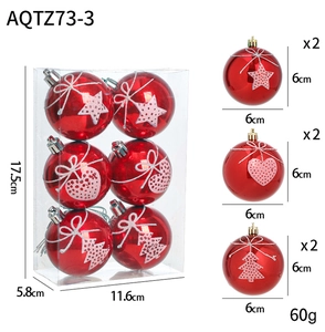 Detailed view of red Christmas ball set with star and heart embossed patterns in gift box