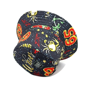 Detail of printed bucket hat featuring black background with crab and wave graffiti