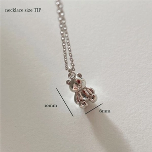 Detailed macro view showing the 10mm silver teddy bear pendant size and texture