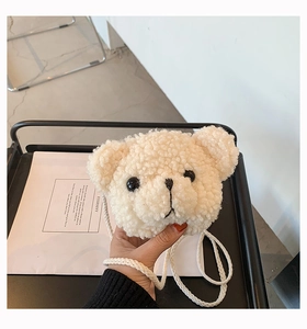 Close-up of fluffy cream plush bear crossbody bag featuring soft texture and embroidery