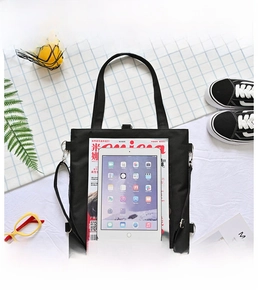Detailed top view of a black canvas tote bag showing its large capacity for iPad and books