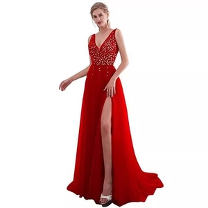 Detail of red V-neck evening gown featuring sequin embroidery and a high slit skirt
