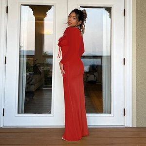 Detail of red slim fit maxi dress with ruffled sleeves and elastic knitted fabric