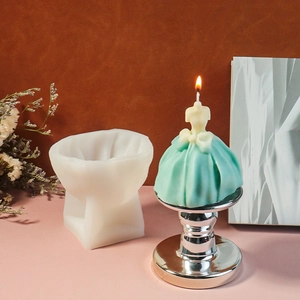 Detail view of large wedding dress silicone mold and handmade wax candle with bow decoration