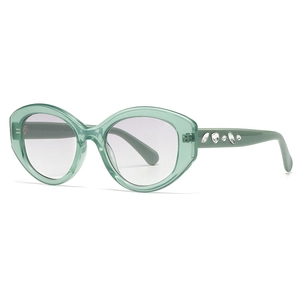 Chic oval narrow translucent green sunglasses with diamond-studded temples for women