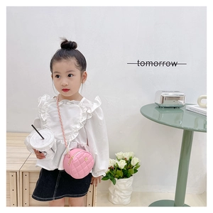 Pink quilted round mini crossbody bag for kids with gold chain strap on child model