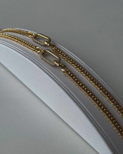 Detail of gold-plated Cuban chain necklace featuring a crystal-encrusted oval clasp