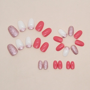 Oval rose pink press-on nails set with glitter details and French tip designs
